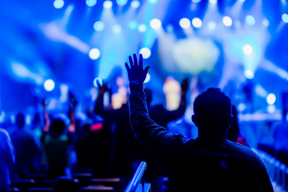Concert audience with blue stage lighting for live show atmosphere