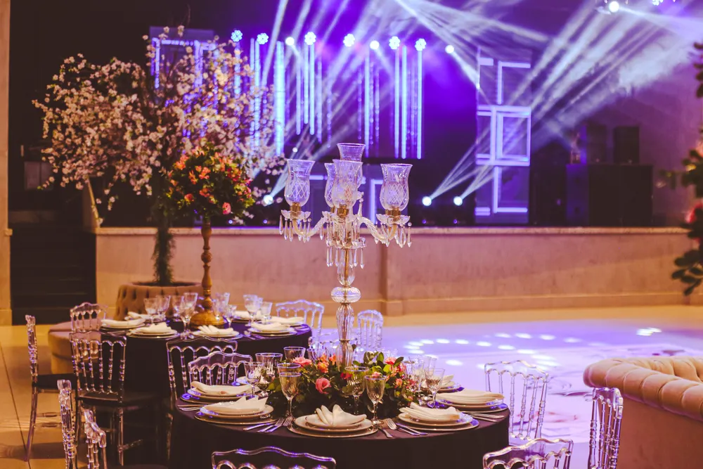 Elegant table setup near a stage with party lighting